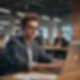 A young professional working on a laptop in a modern office space